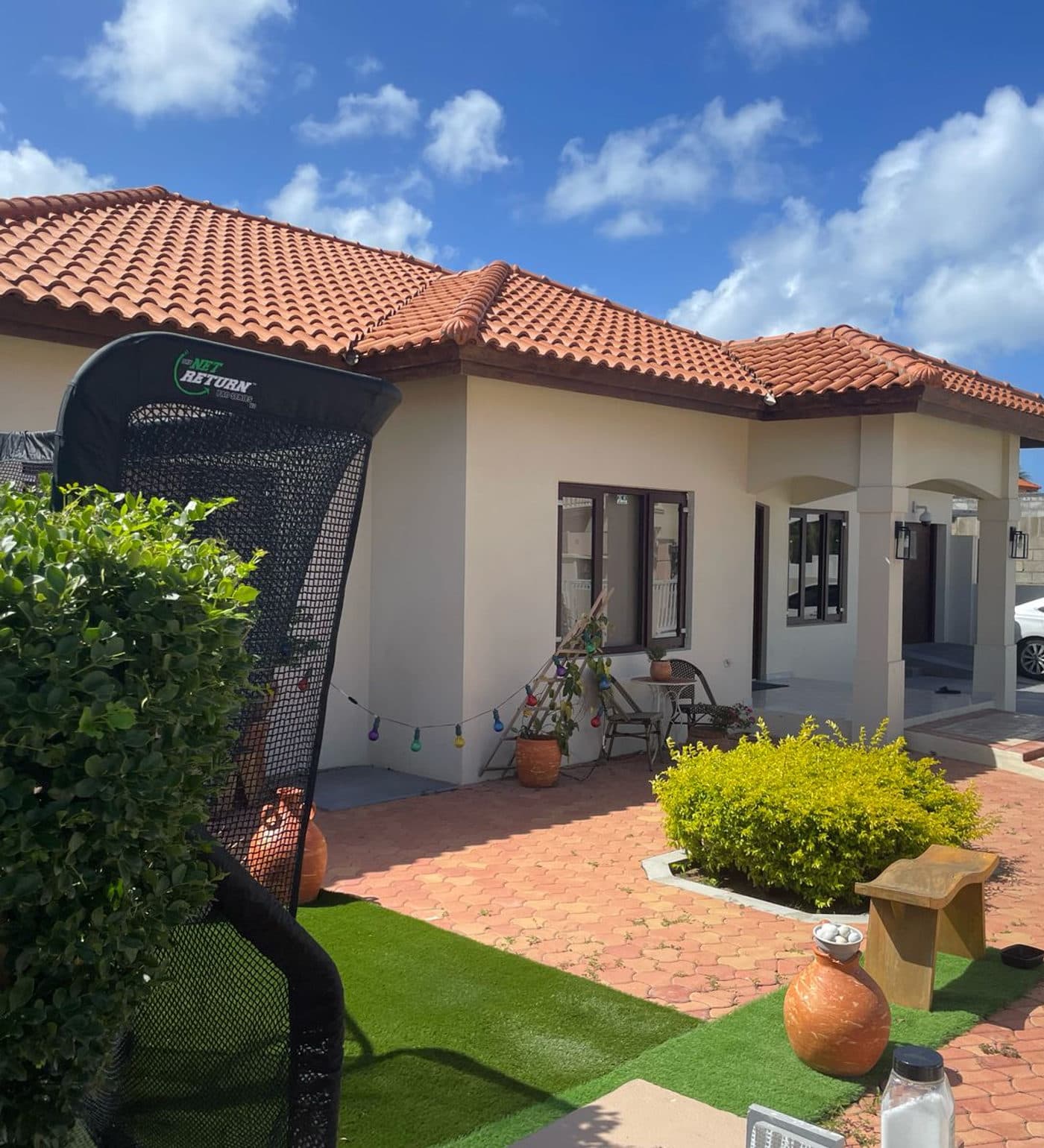Villa with terracotta roof and tropical garden in Wayaca, Aruba